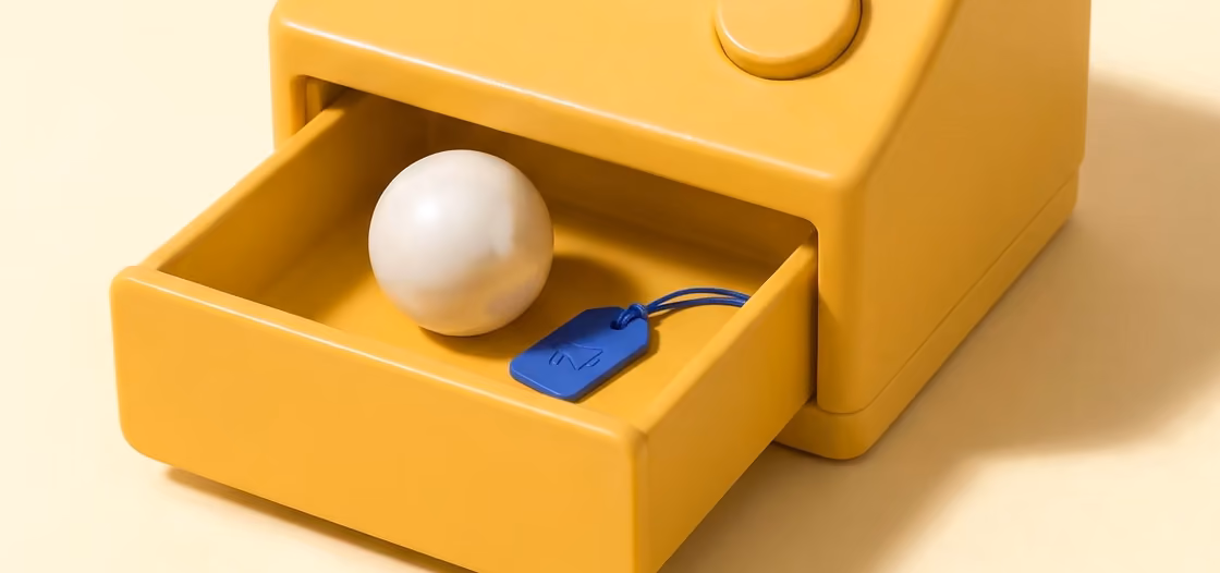The butter till's drawer, open on a pearl ball wearing a small blue tag: the sold job, traced to the ad that brought it